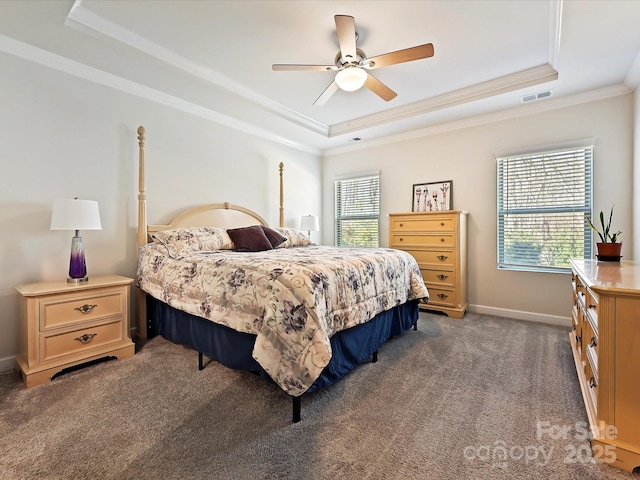 carpeted bedroom featuring a raised ceiling, ornamental molding, ceiling fan, and multiple windows