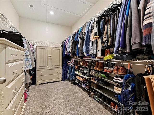 spacious closet with attic access, visible vents, and carpet flooring