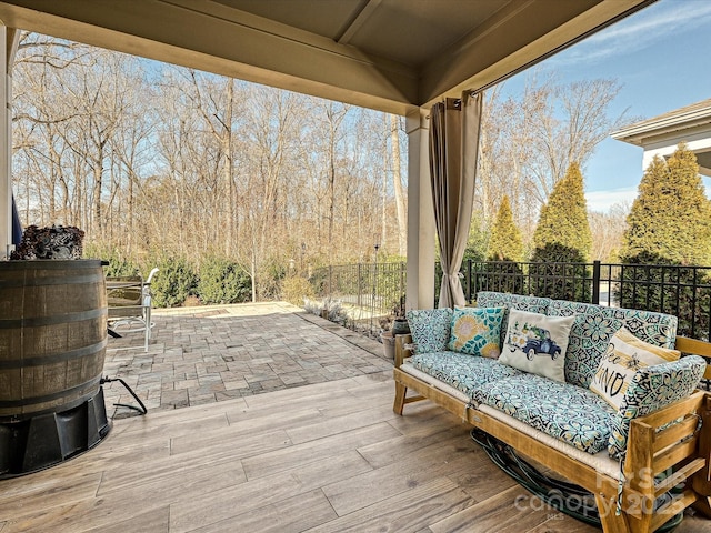 deck featuring a patio area, an outdoor living space, and fence