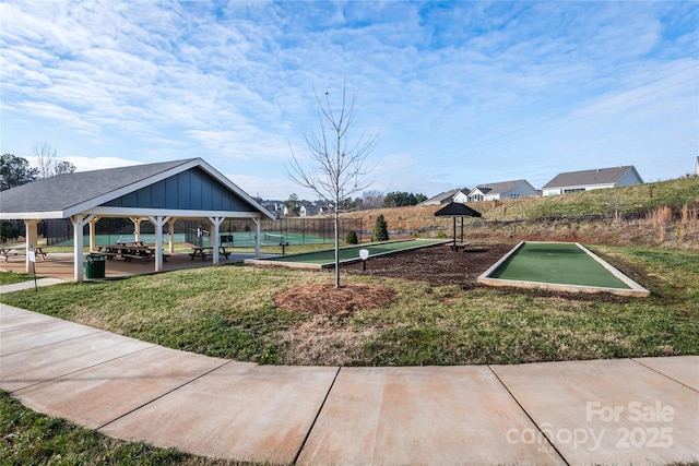 view of home's community with a gazebo, fence, and a lawn