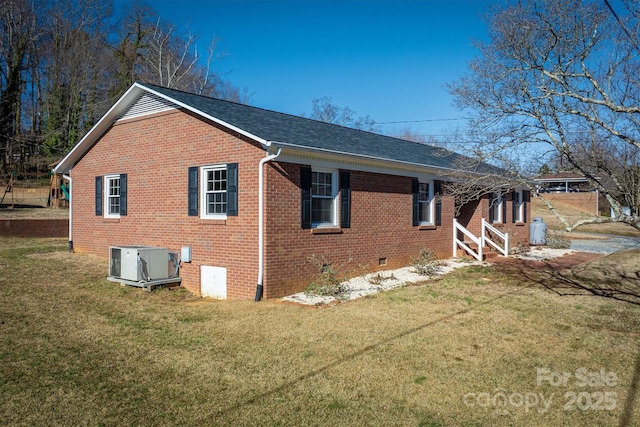 view of property exterior with crawl space, brick siding, central AC, and a yard