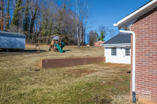 view of yard with a shed and a playground