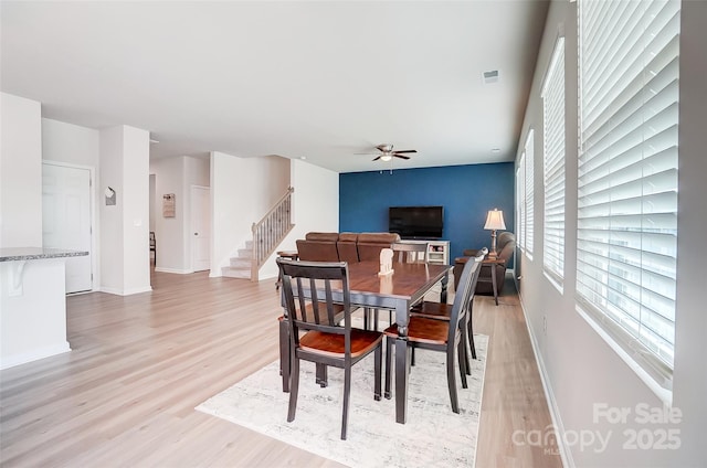 dining room featuring ceiling fan and light wood-type flooring