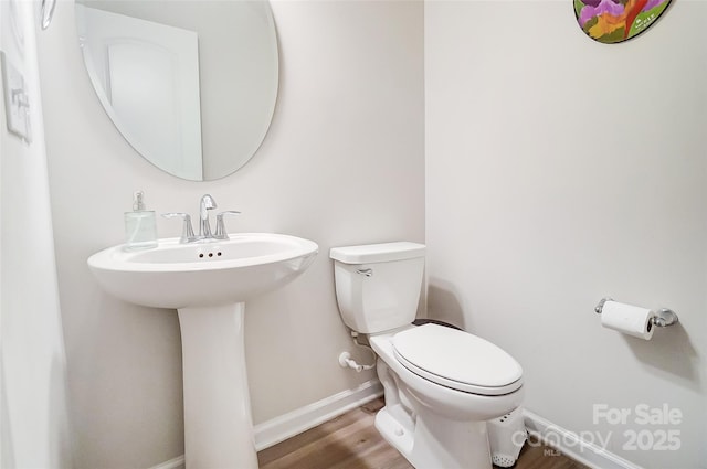 bathroom with wood-type flooring and toilet