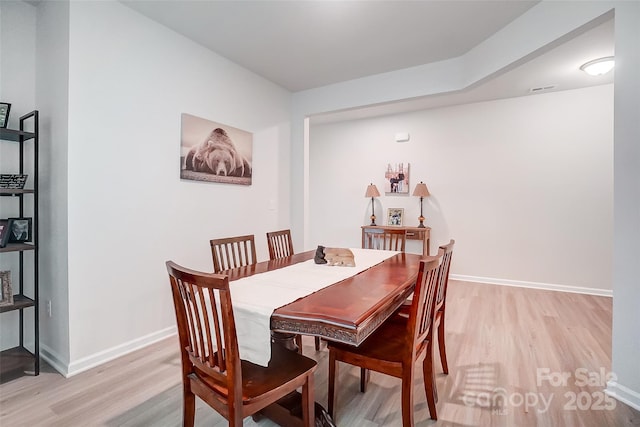 dining area with light hardwood / wood-style floors