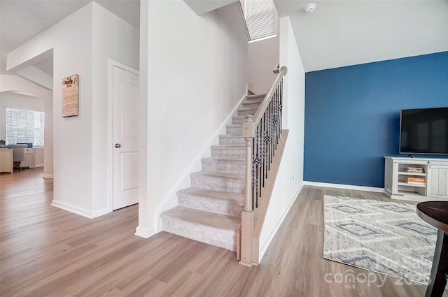 stairway featuring wood-type flooring