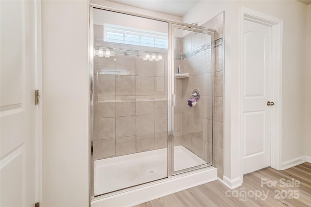 bathroom featuring hardwood / wood-style flooring and walk in shower