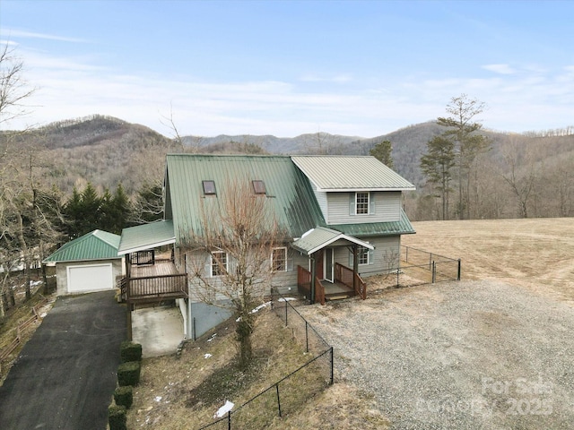 view of front of property with a mountain view, a garage, and an outdoor structure