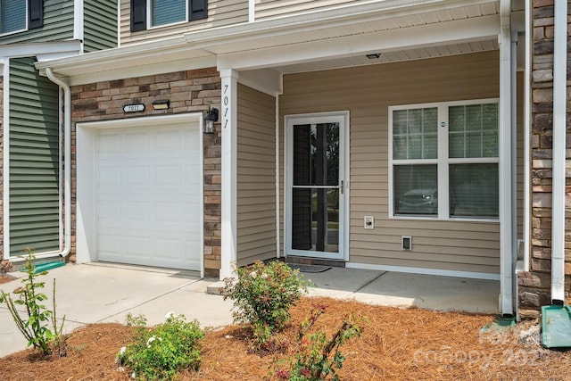 view of exterior entry with a garage