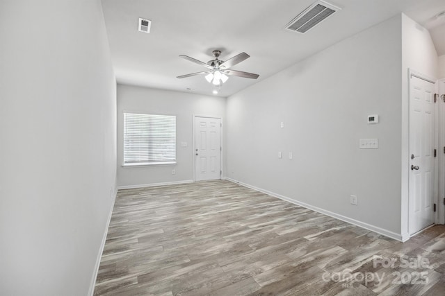 spare room featuring light hardwood / wood-style floors and ceiling fan