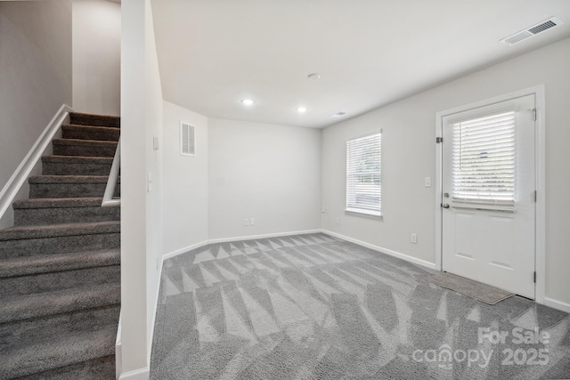 foyer featuring light colored carpet