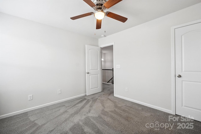 unfurnished bedroom featuring light colored carpet and ceiling fan