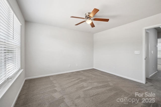 carpeted empty room featuring ceiling fan