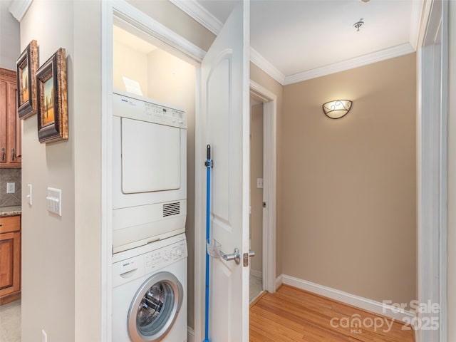 330 Bowling Park Rd, Asheville, NC 28803 - laundry area featuring crown molding, stacked washer / drying machine, and light hardwood / wood-style floors