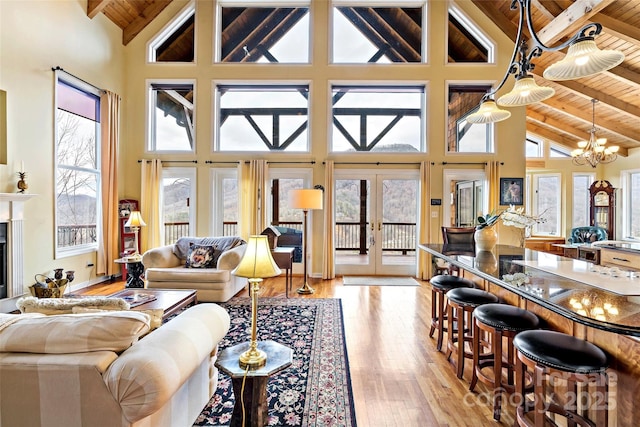 living room with light wood-type flooring, high vaulted ceiling, and wooden ceiling