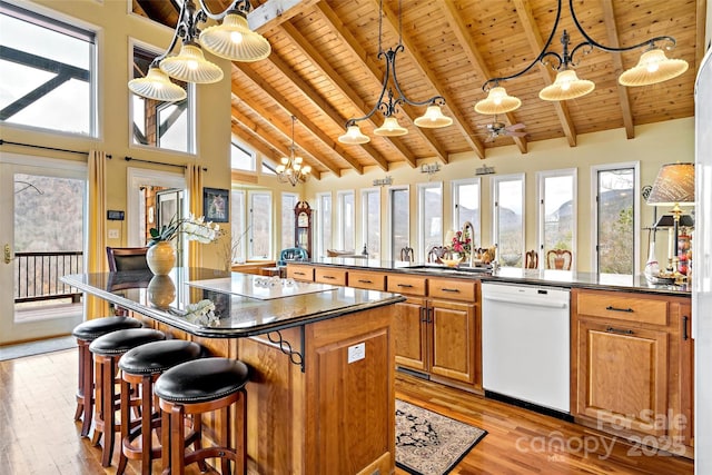 kitchen featuring high vaulted ceiling, decorative light fixtures, dishwasher, wood ceiling, and beam ceiling