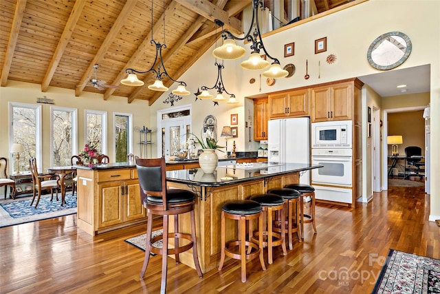 kitchen with pendant lighting, high vaulted ceiling, wooden ceiling, beamed ceiling, and white appliances