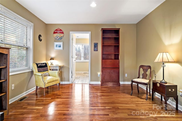 sitting room featuring hardwood / wood-style floors and a healthy amount of sunlight