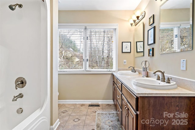 bathroom featuring shower / bathing tub combination, vanity, plenty of natural light, and tile patterned floors