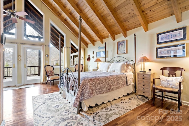 bedroom with wood-type flooring, beam ceiling, access to exterior, and wooden ceiling