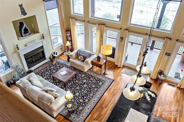 living room featuring wood-type flooring and a high ceiling