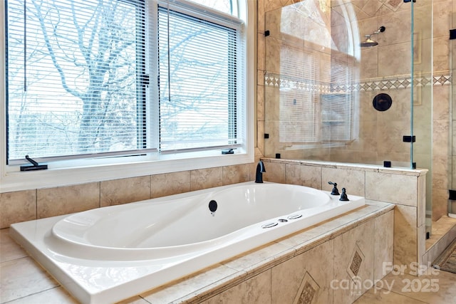 bathroom with shower with separate bathtub and plenty of natural light