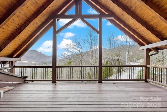 wooden terrace featuring a water and mountain view