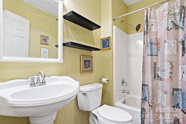 full bathroom featuring toilet, shower / bathtub combination with curtain, and sink