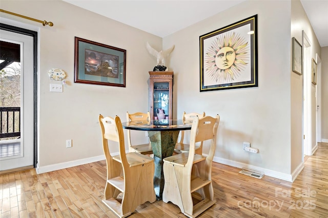 dining area with wood-type flooring