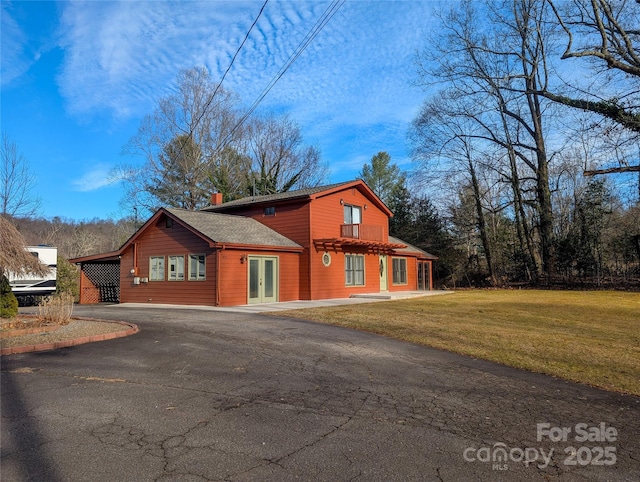 view of property exterior with a carport and a yard