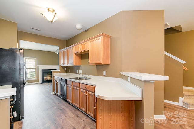 7117 Flying Scotsman Dr, Charlotte, NC 28213 - kitchen with freestanding refrigerator, dishwasher, a sink, light wood-type flooring, and light countertops