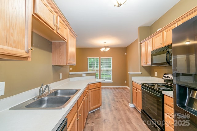 7117 Flying Scotsman Dr, Charlotte, NC 28213 - kitchen featuring black appliances, light brown cabinetry, a sink, and light countertops