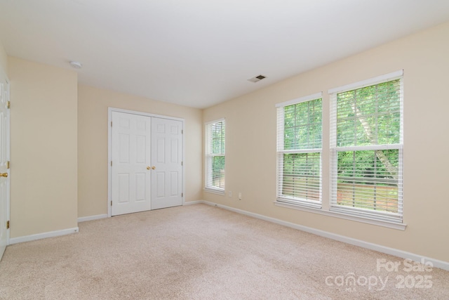7117 Flying Scotsman Dr, Charlotte, NC 28213 - unfurnished bedroom with light colored carpet, baseboards, and a closet