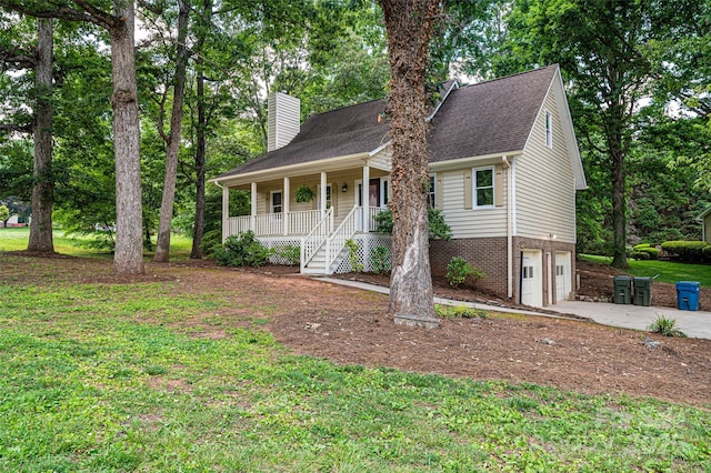 view of front facade with a garage, covered porch, and a front yard