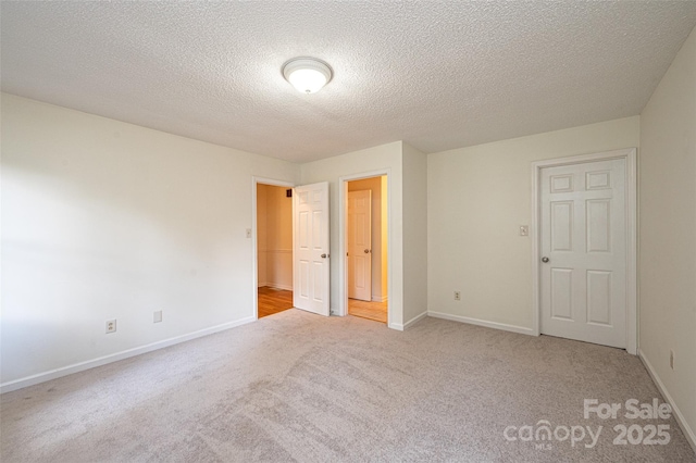 carpeted spare room with a textured ceiling