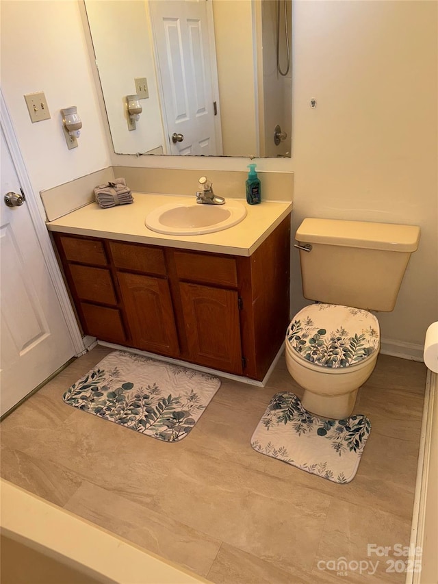 bathroom with vanity, tile patterned floors, and toilet