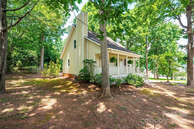 view of property exterior with a porch