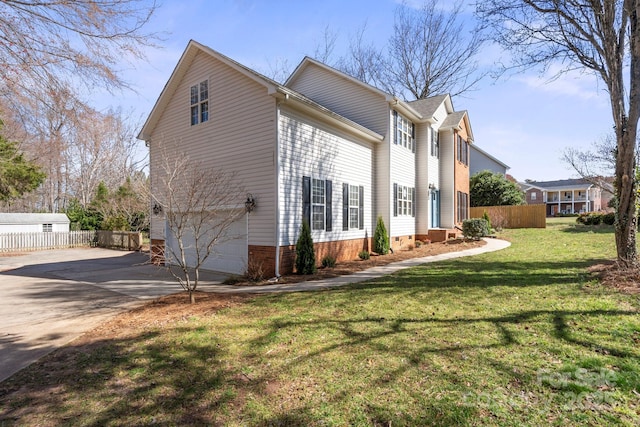 view of property exterior featuring concrete driveway, an attached garage, fence, and a yard