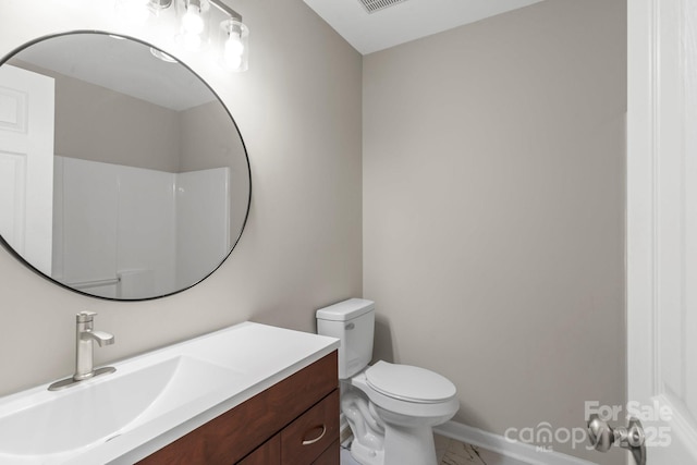 bathroom featuring vanity, toilet, and marble finish floor