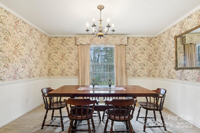 dining area featuring crown molding, carpet floors, and a notable chandelier