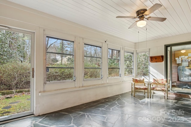 unfurnished sunroom with wooden ceiling and ceiling fan