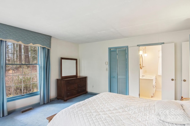 carpeted bedroom with ensuite bath