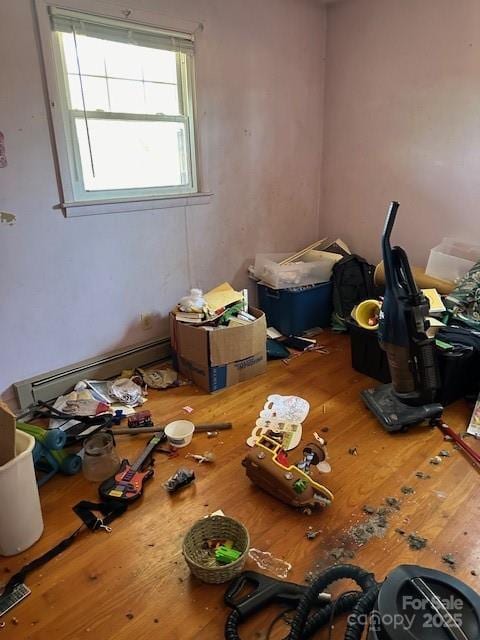 miscellaneous room featuring a baseboard radiator and hardwood / wood-style floors