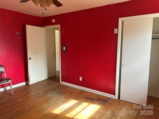 unfurnished bedroom with a closet, hardwood / wood-style floors, and a textured ceiling