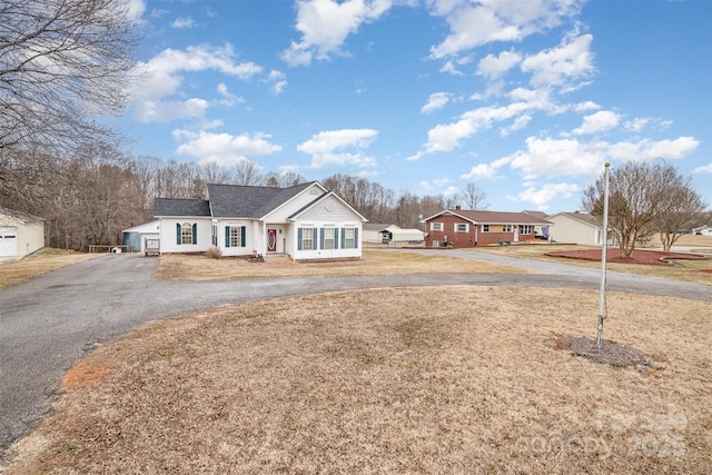 single story home featuring a garage and a front yard