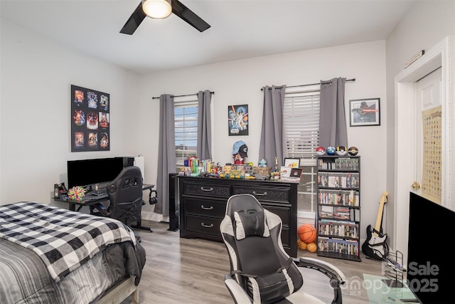 bedroom with ceiling fan and light hardwood / wood-style floors