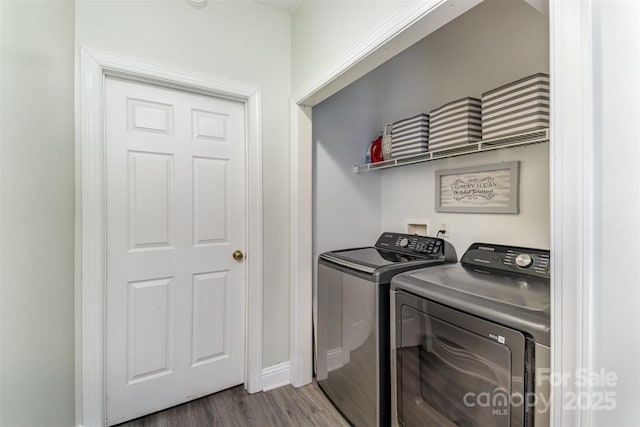 laundry room with independent washer and dryer and wood-type flooring