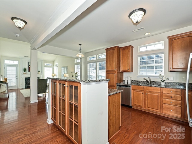 kitchen with a healthy amount of sunlight, dishwasher, hanging light fixtures, a center island, and dark wood-type flooring