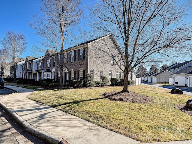 view of home's exterior with a garage and a lawn