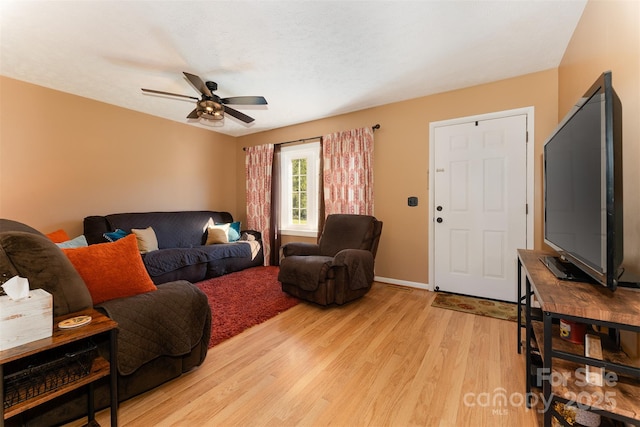 living room featuring ceiling fan and light hardwood / wood-style flooring